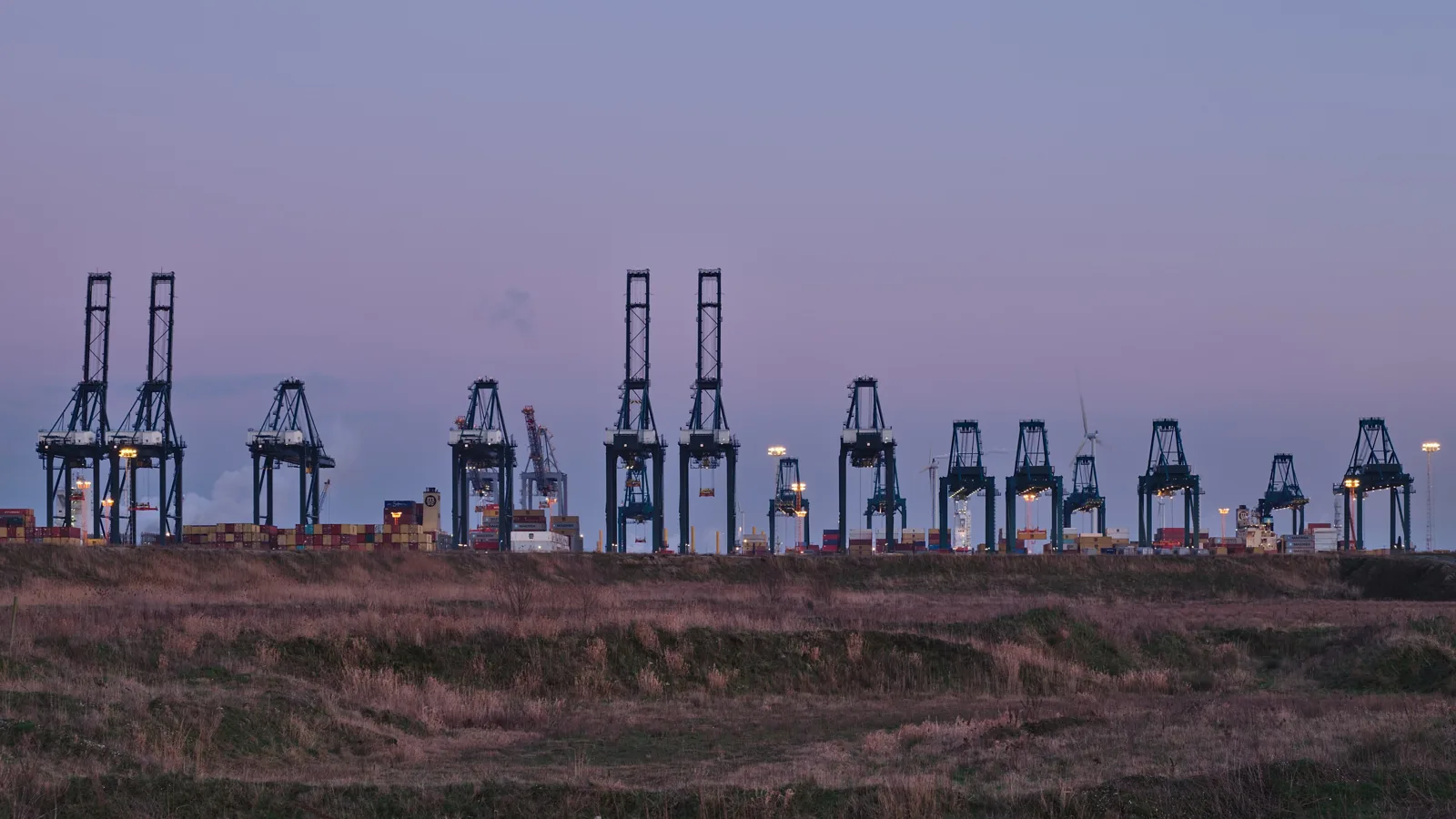 Container cranes at the MSC PSA European Terminal in the Port of Antwerp at twilight