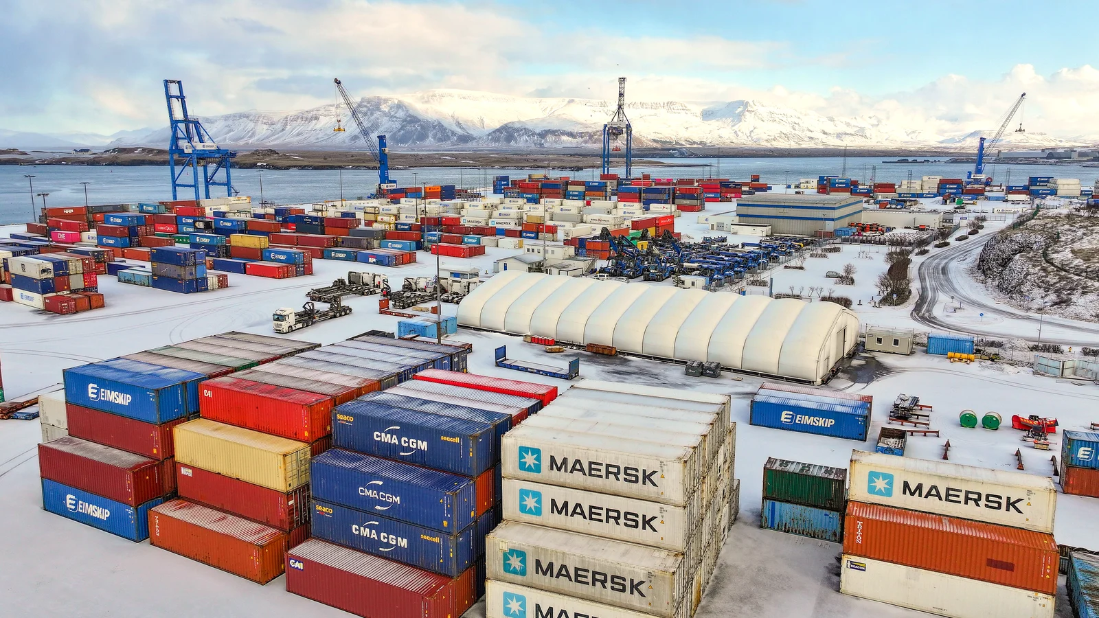 Stacked containers and gantry cranes at the container terminal in Reykjavik port