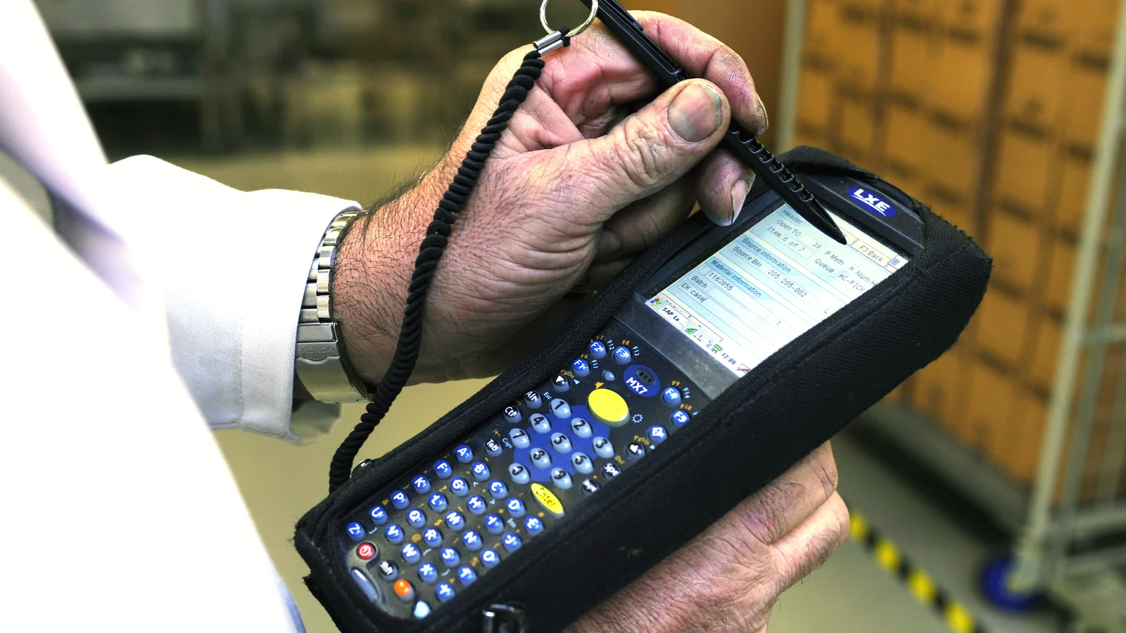Handheld barcode scanner reading a package label