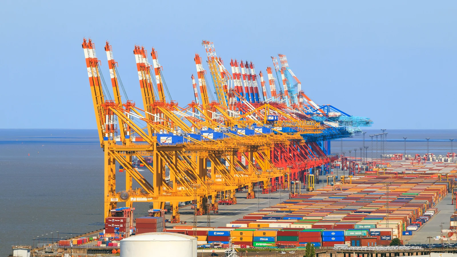 Row of gantry cranes over stacked containers at the Bremerhaven container terminal