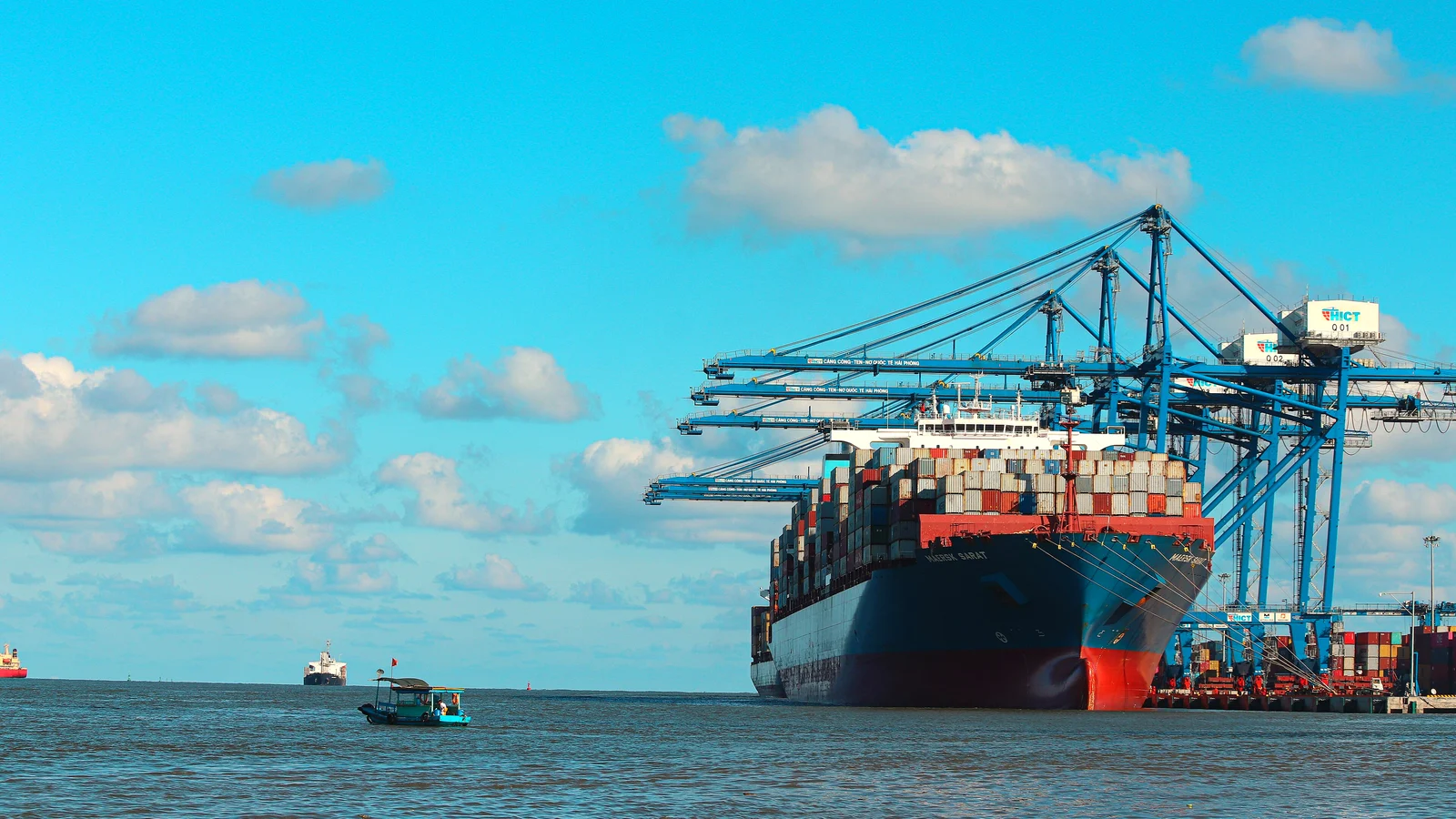 Container ship berthed under gantry cranes at Hai Phong International Container Terminal, Vietnam